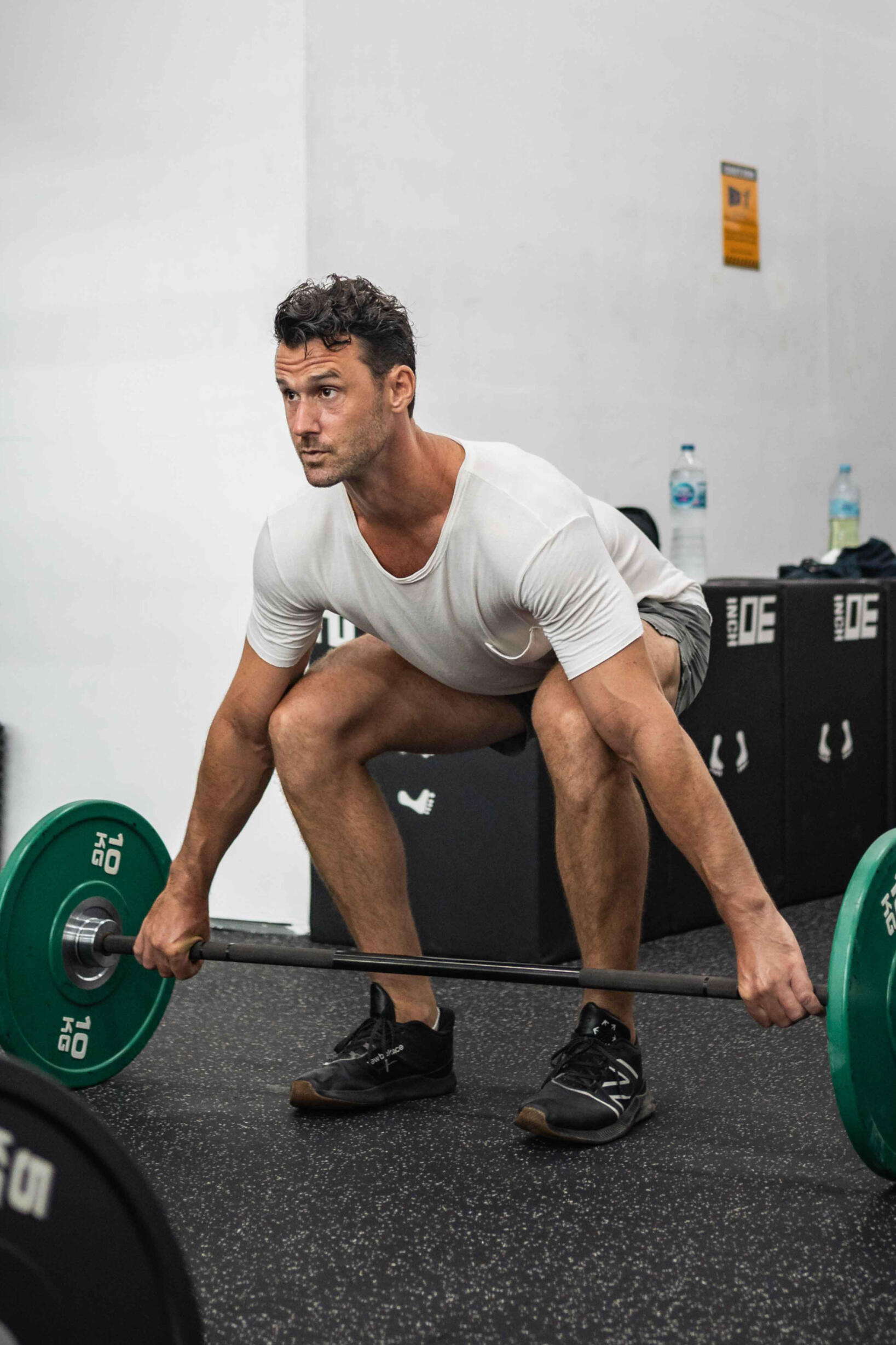 Paul Marlow doing a half kneeling dumbbell single arm press this is a photo of Paul Marlow doing a half kneeling dumbbell single arm press